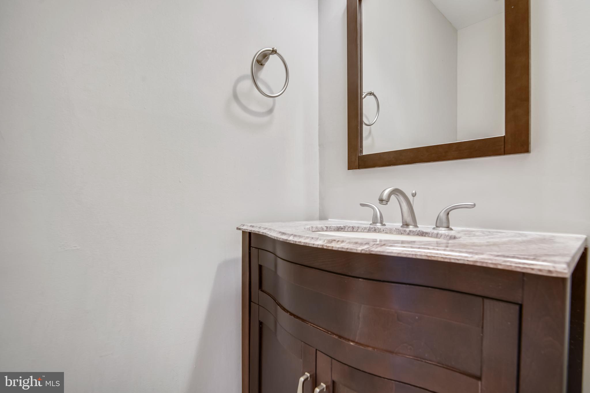 2241 Aberdeen Drive Crofton, MD 21114 - Photo 31 of 37 a bathroom with a granite countertop sink a mirror and vanity