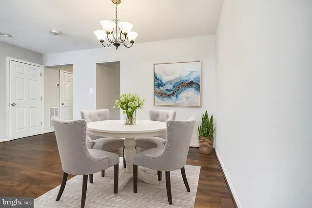 a dining room with furniture and chandelier