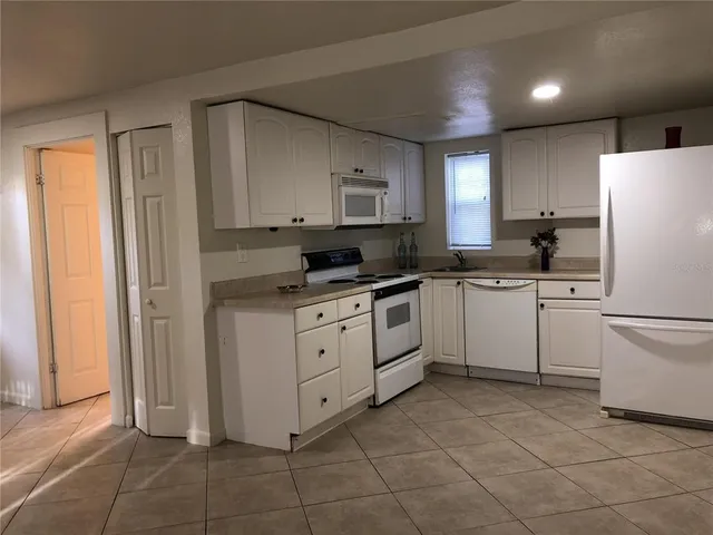 a kitchen with a white cabinets and white appliances