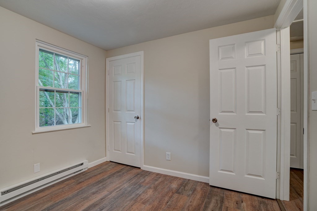 111 Bemis Road Warren, MA 01585 - Photo 16 of 25 a view of an empty room with wooden floor and a window