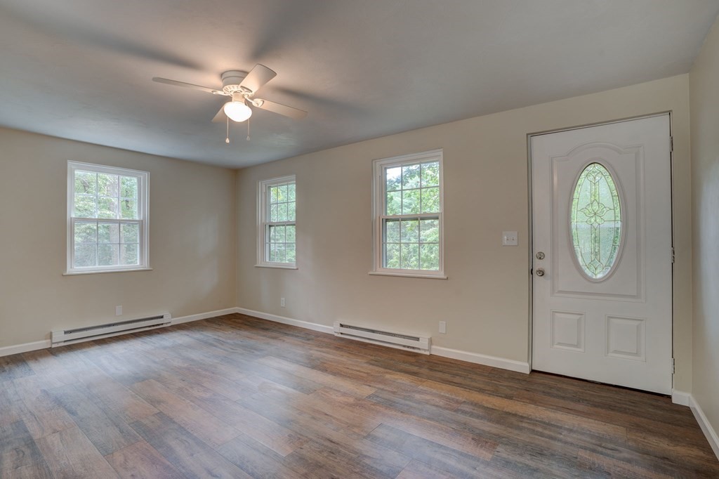 111 Bemis Road Warren, MA 01585 - Photo 5 of 25 a view of an empty room with wooden floor and window