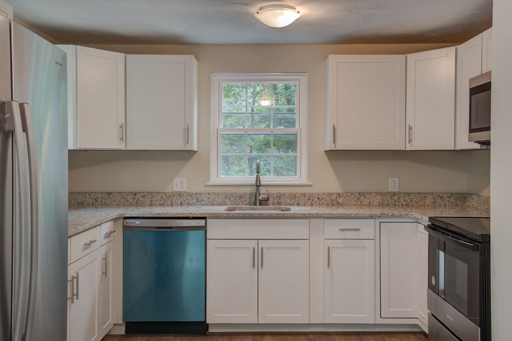 111 Bemis Road Warren, MA 01585 - Photo 7 of 25 a kitchen with granite countertop white cabinets and a sink