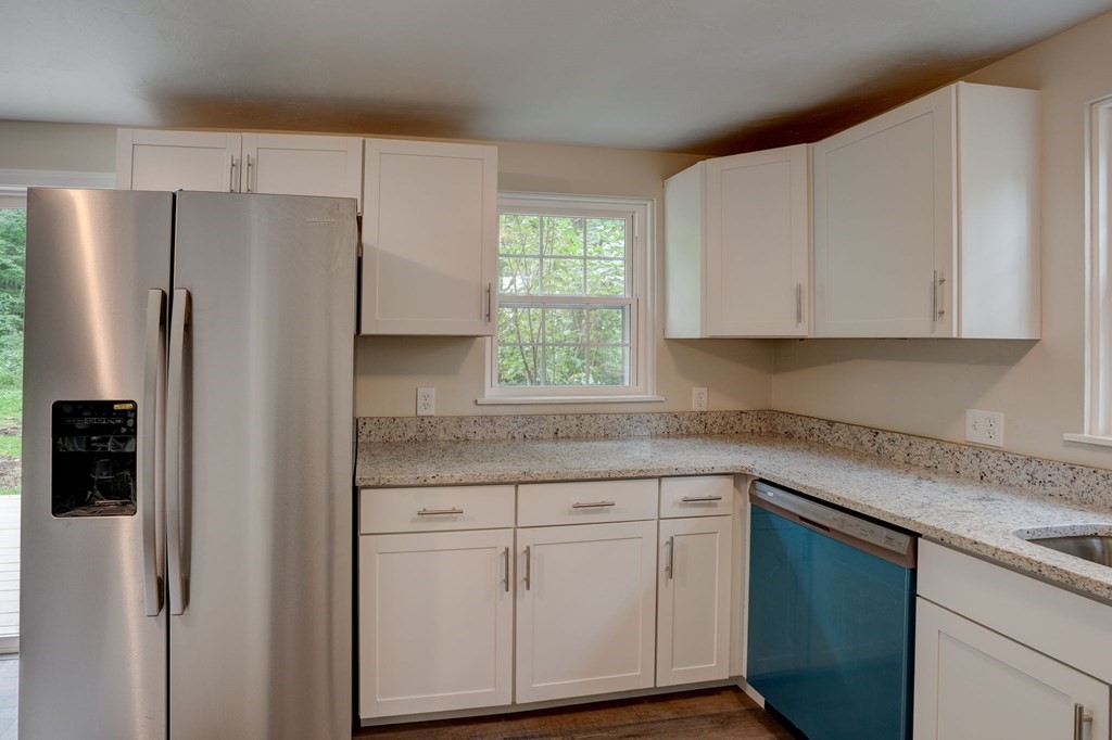 111 Bemis Road Warren, MA 01585 - Photo 9 of 25 a kitchen with white cabinets white stainless steel appliances and refrigerator
