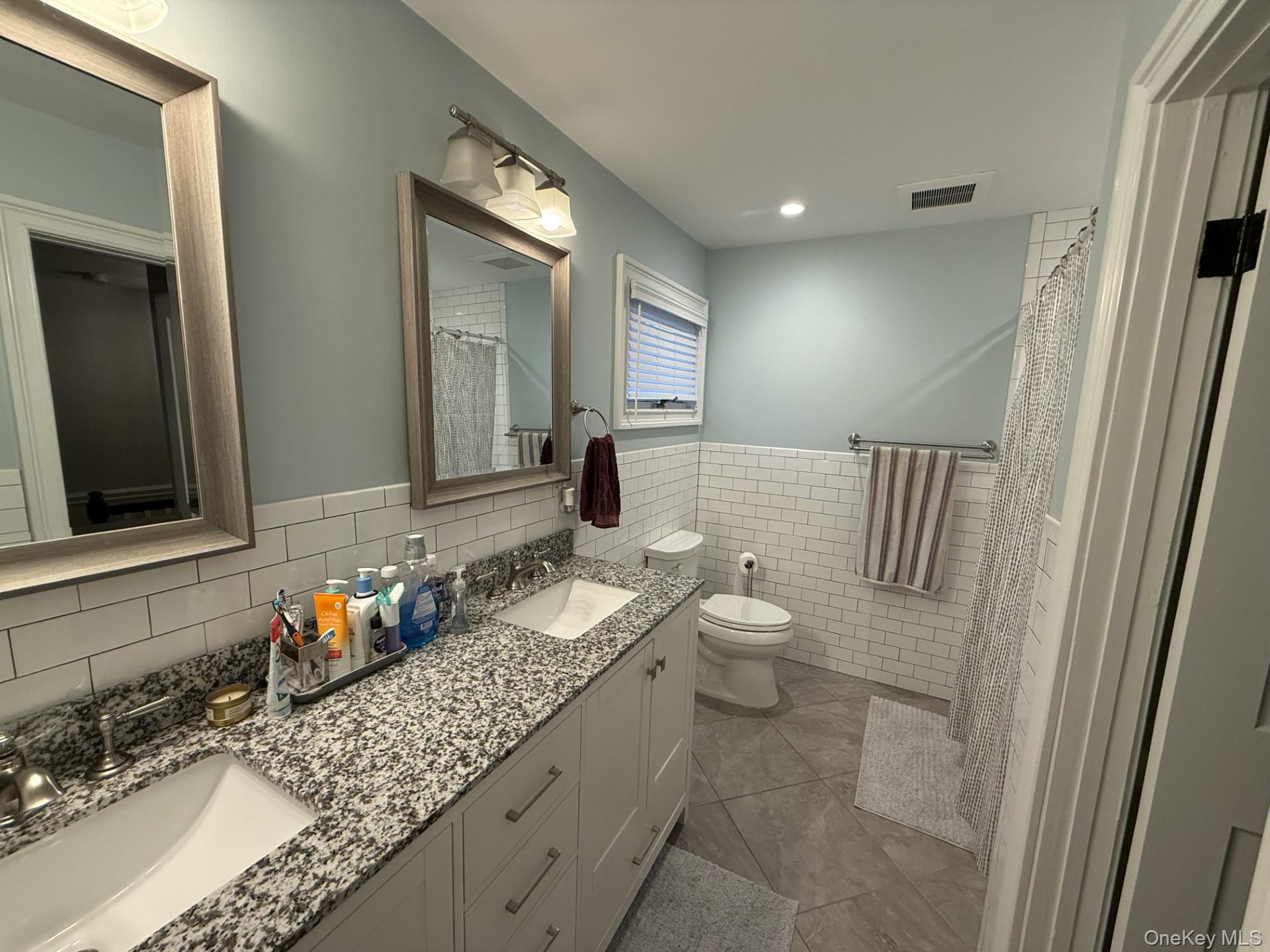 3 Pimlico Court Commack, NY 11725 - Photo 25 of 33 a bathroom with a granite countertop sink and a mirror