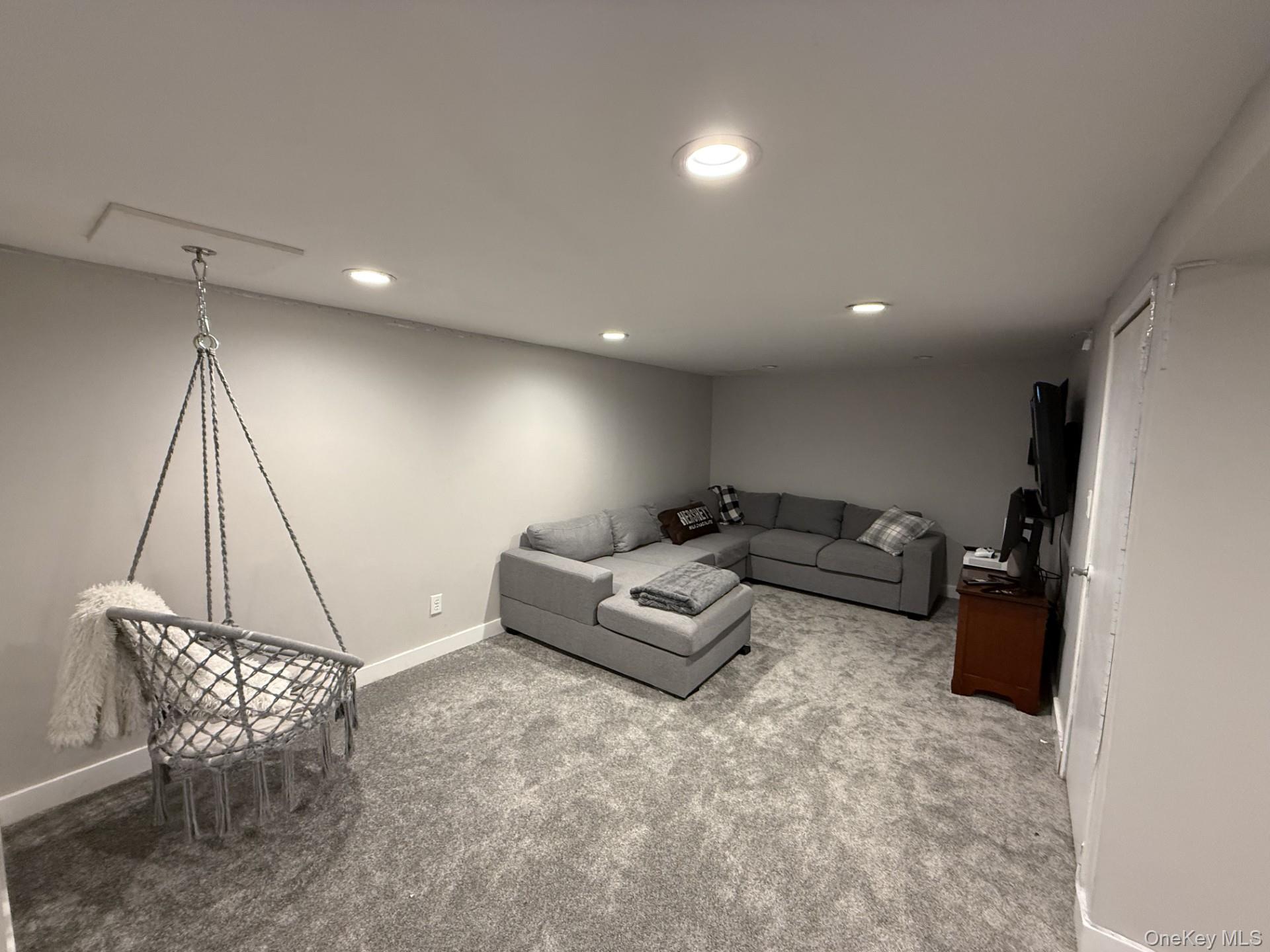 3 Pimlico Court Commack, NY 11725 - Photo 27 of 33 a living room with furniture and a wooden floor