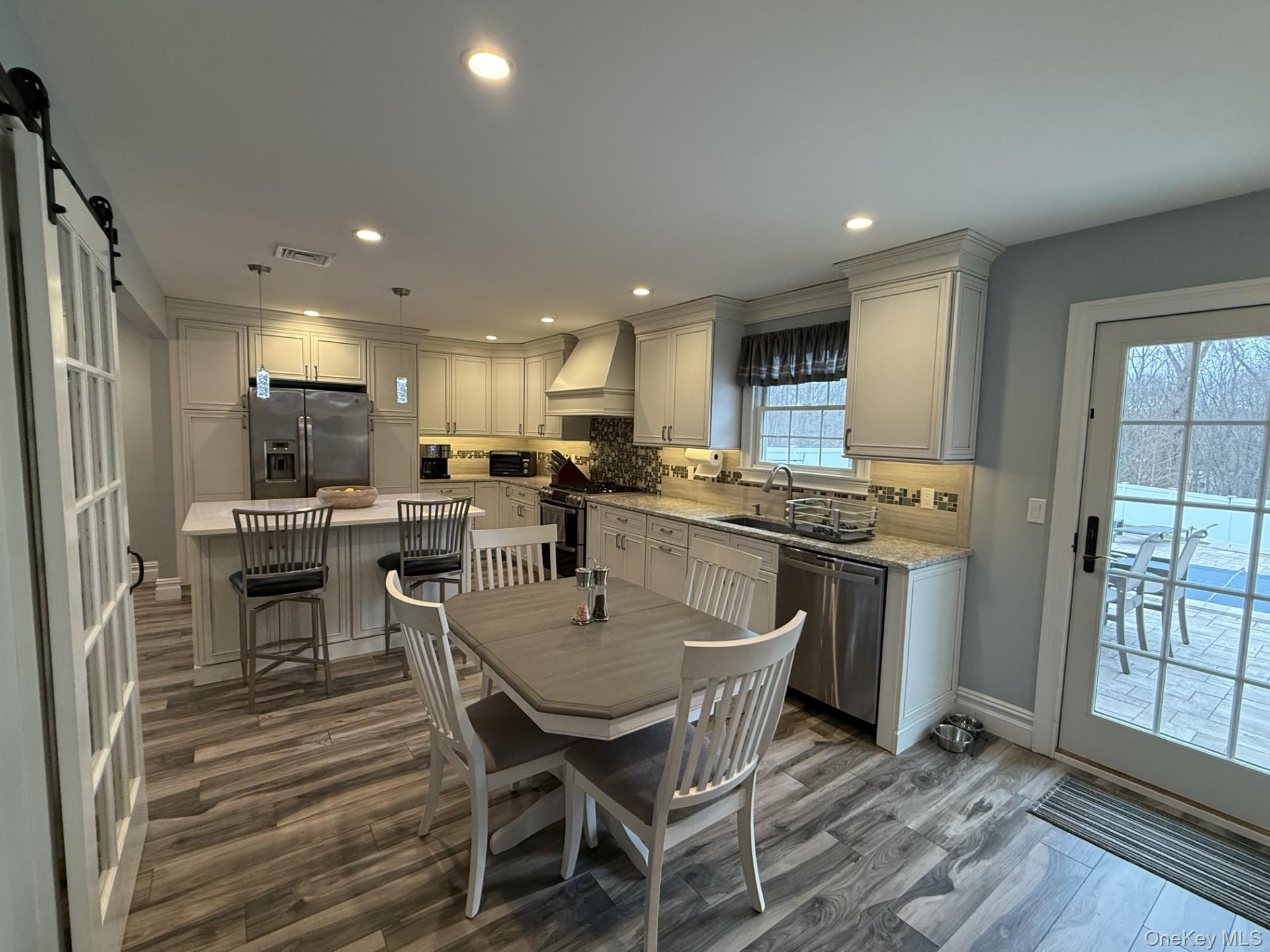 3 Pimlico Court Commack, NY 11725 - Photo 4 of 33 a kitchen with a dining table chairs and refrigerator