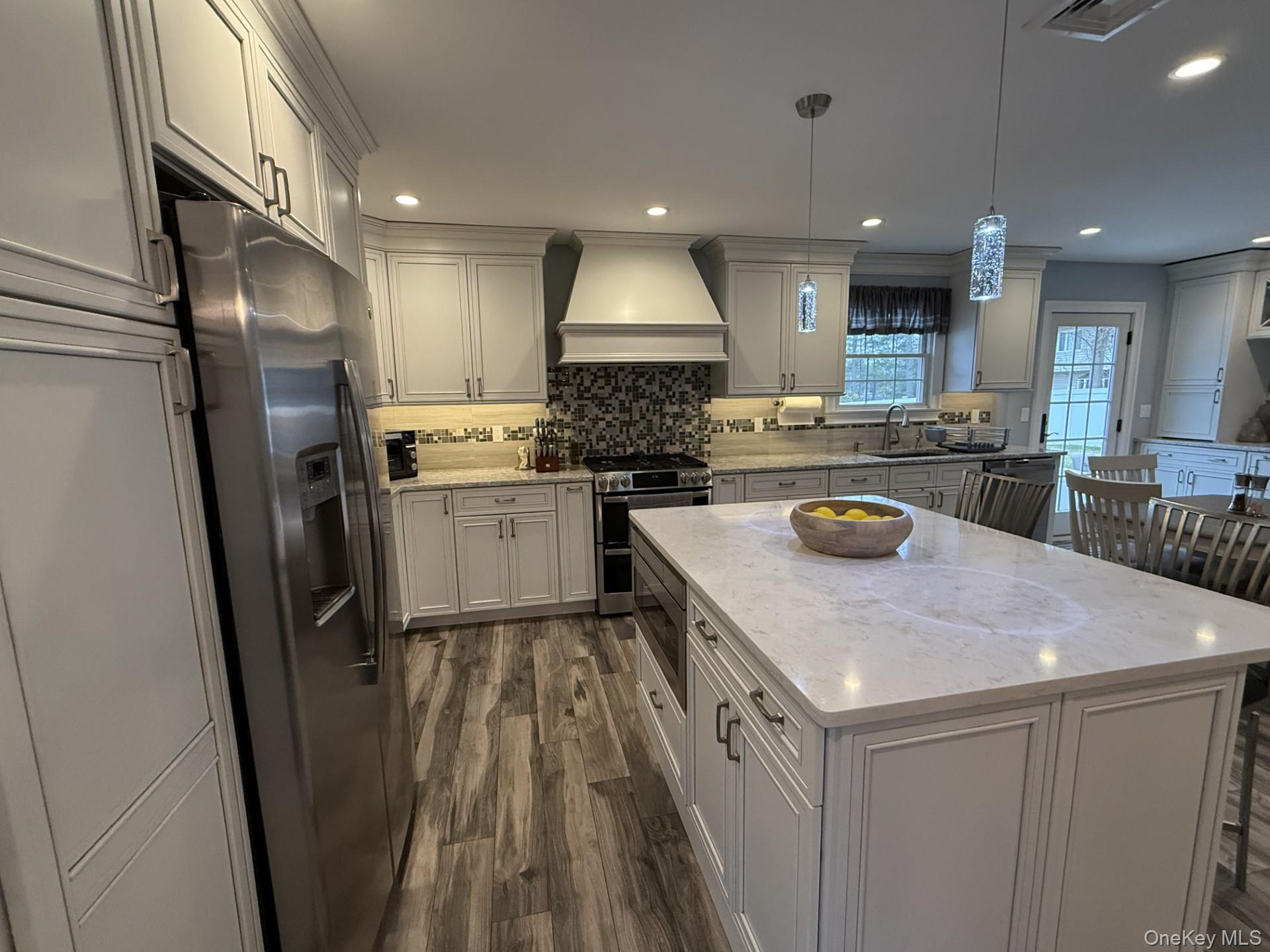 3 Pimlico Court Commack, NY 11725 - Photo 7 of 33 a kitchen with a sink a stove a refrigerator and cabinets