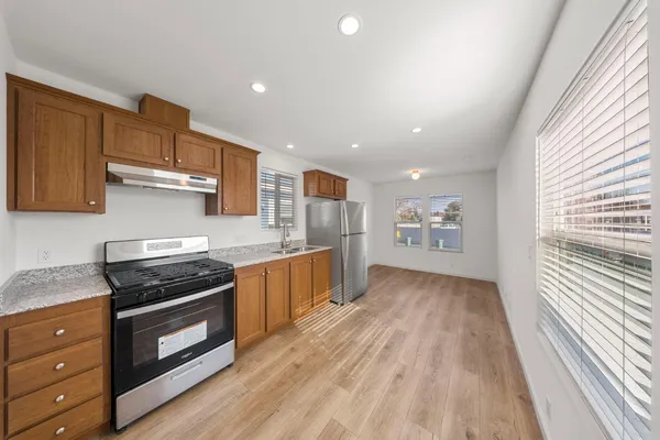 a kitchen with granite countertop a stove and a sink