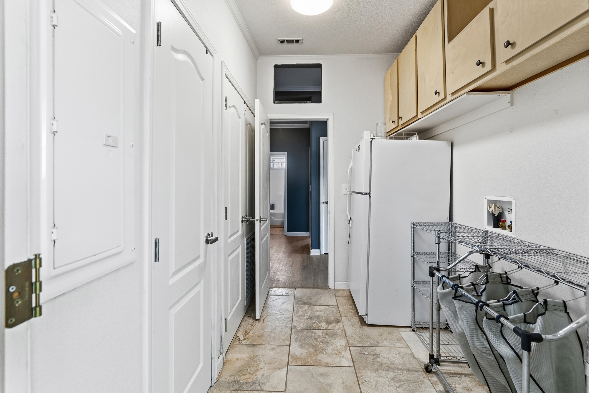 1951 Dowdy Road Seguin, TX 78155 - Photo 16 of 40 A functional utility space features durable tile flooring and abundant built-in cabinet storage.