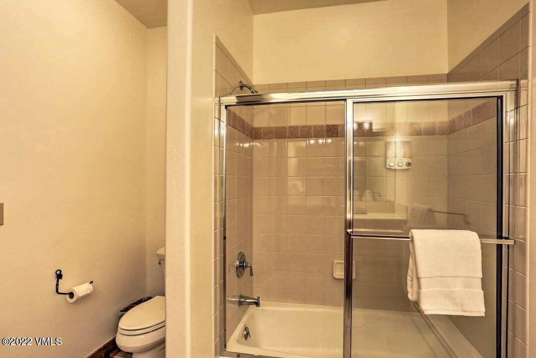 178 Knudson Ranch Road Edwards, CO 81632 - Photo 12 of 26 a bathroom with a glass shower door