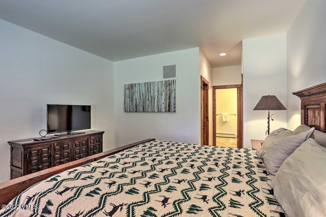 178 Knudson Ranch Road Edwards, CO 81632 - Photo 14 of 26 a bedroom with a bed and a flat screen tv