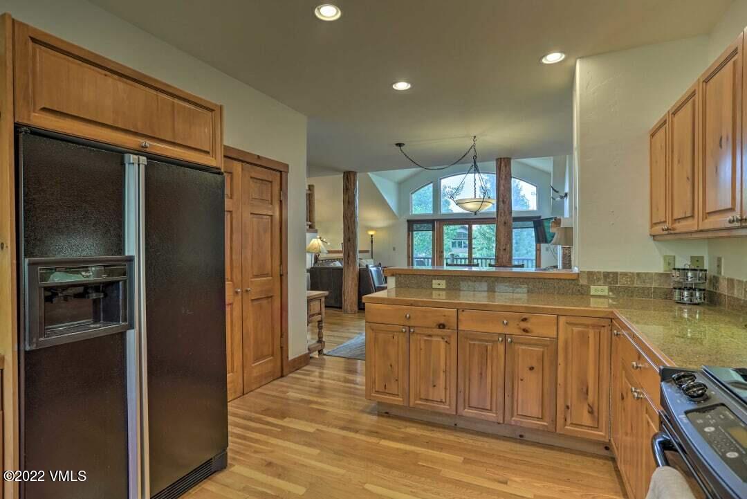178 Knudson Ranch Road Edwards, CO 81632 - Photo 18 of 26 a kitchen with stainless steel appliances granite countertop a refrigerator and a sink