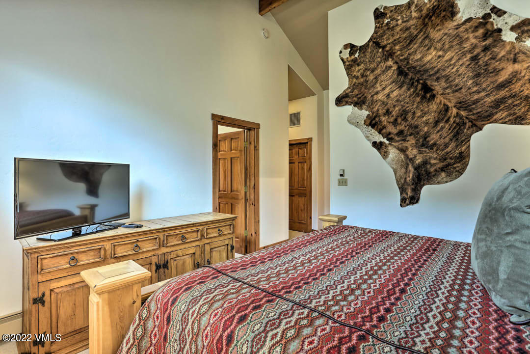 178 Knudson Ranch Road Edwards, CO 81632 - Photo 25 of 26 a bedroom with a bed and a flat screen tv