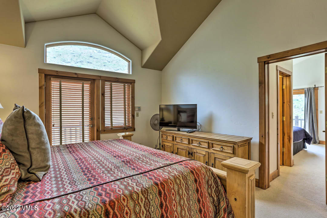 178 Knudson Ranch Road Edwards, CO 81632 - Photo 26 of 26 a bedroom with a bed and a television