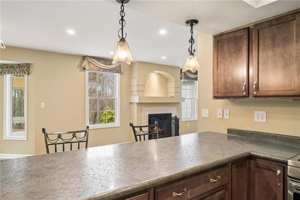317 Ann Circle Indiana, PA 15701 - Photo 12 of 39 a kitchen with stainless steel appliances granite countertop a stove top oven a sink a dining table and chairs with wooden floor