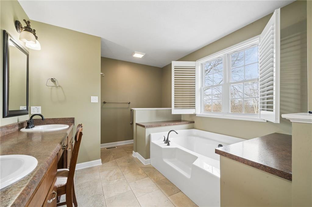 317 Ann Circle Indiana, PA 15701 - Photo 20 of 39 a spacious bathroom with a granite countertop tub sink and mirror