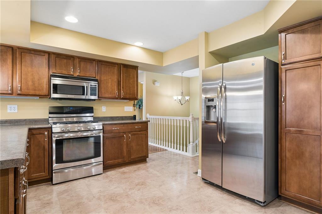 317 Ann Circle Indiana, PA 15701 - Photo 10 of 39 a kitchen with granite countertop a refrigerator and a stove top oven