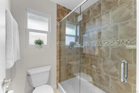a bathroom with a toilet and shower