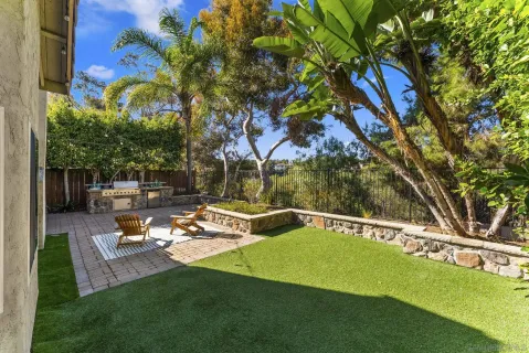 a view of a swimming pool with a bench and trees