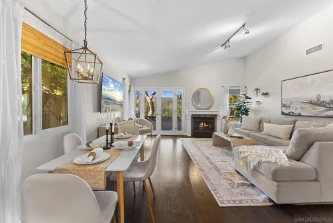 a living room with furniture chandelier and a fireplace