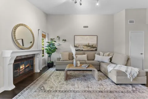 a living room with furniture and a fireplace