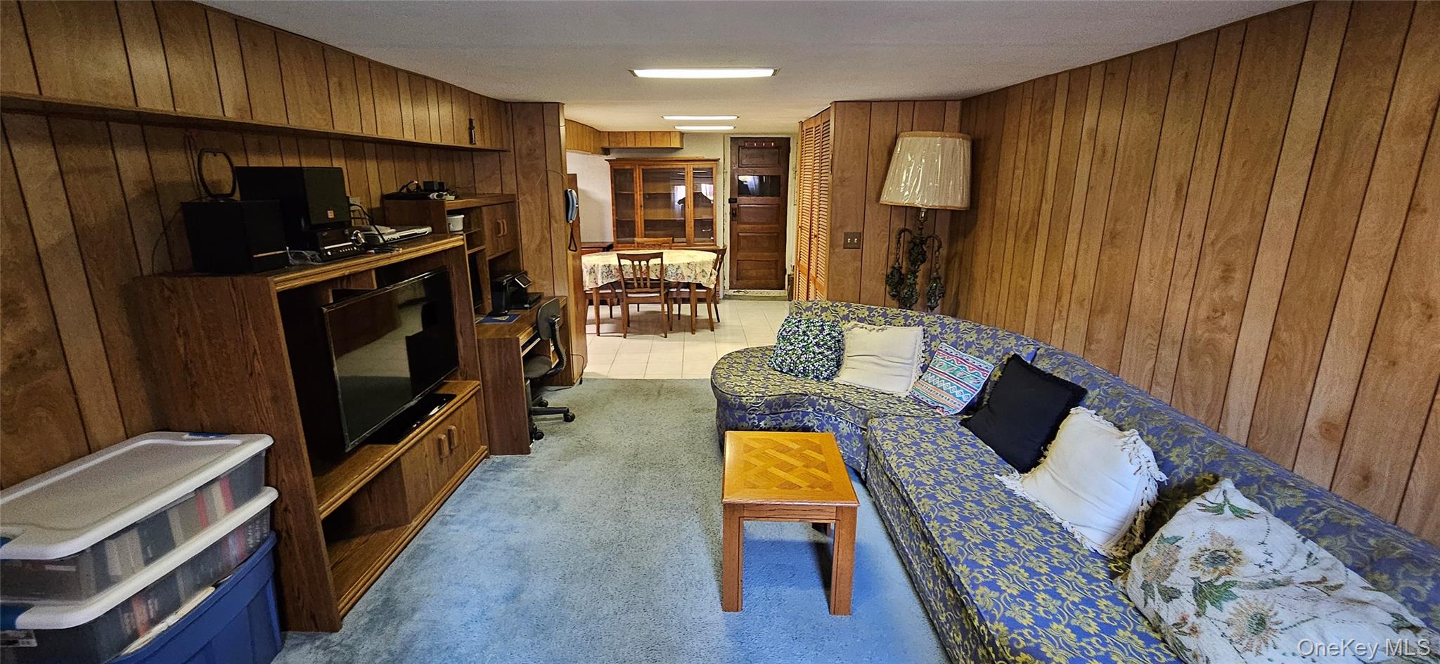 78-54 75th Street Queens, NY 11385 - Photo 13 of 31 Living area featuring wooden walls and light carpet