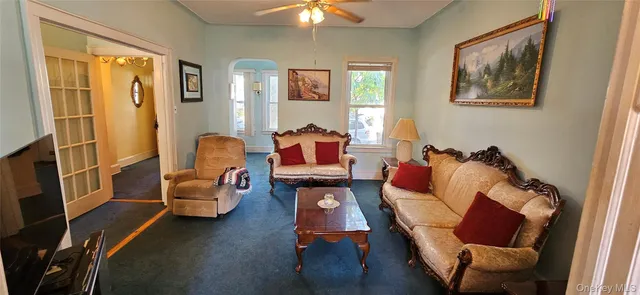 a living room with furniture and a chandelier