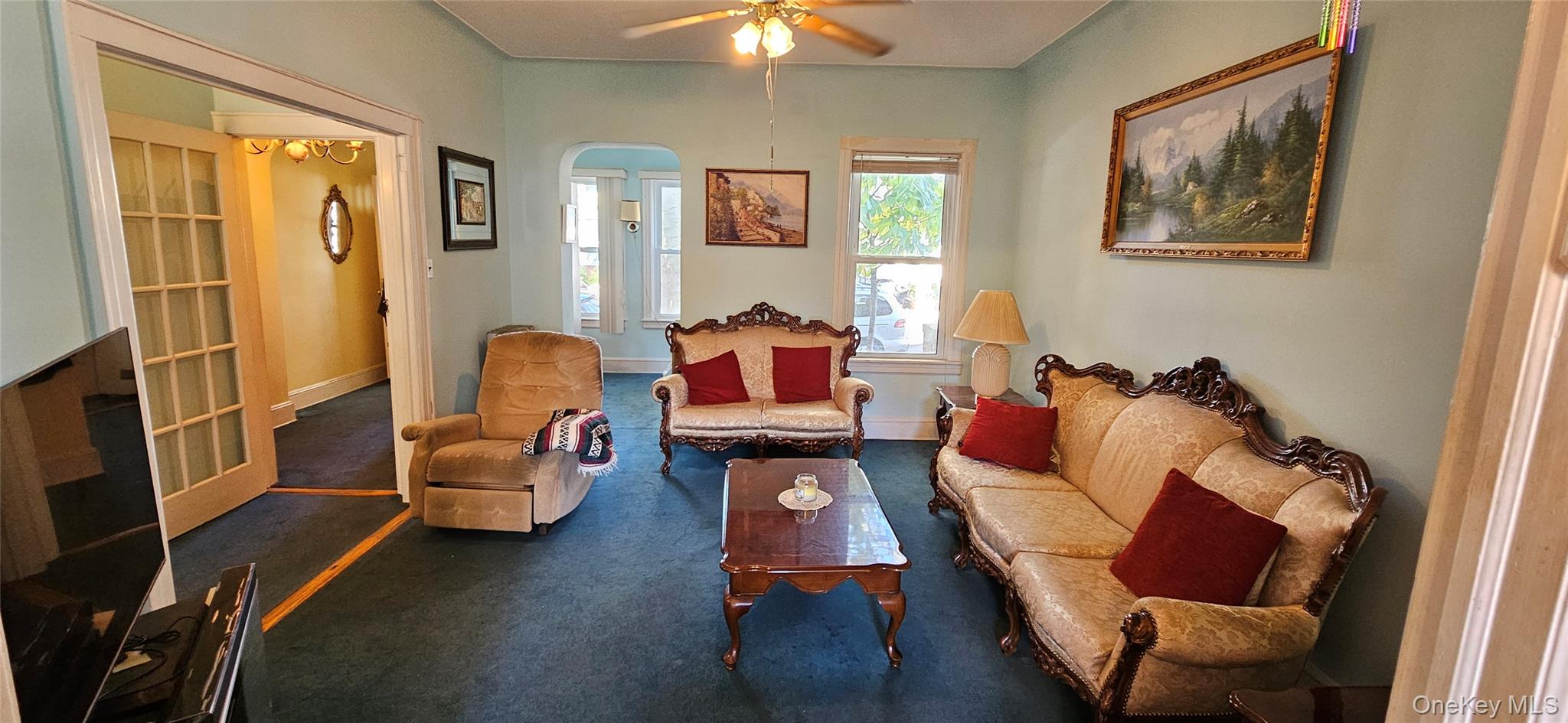 78-54 75th Street Queens, NY 11385 - Photo 2 of 31 Living area with a ceiling fan and carpet flooring