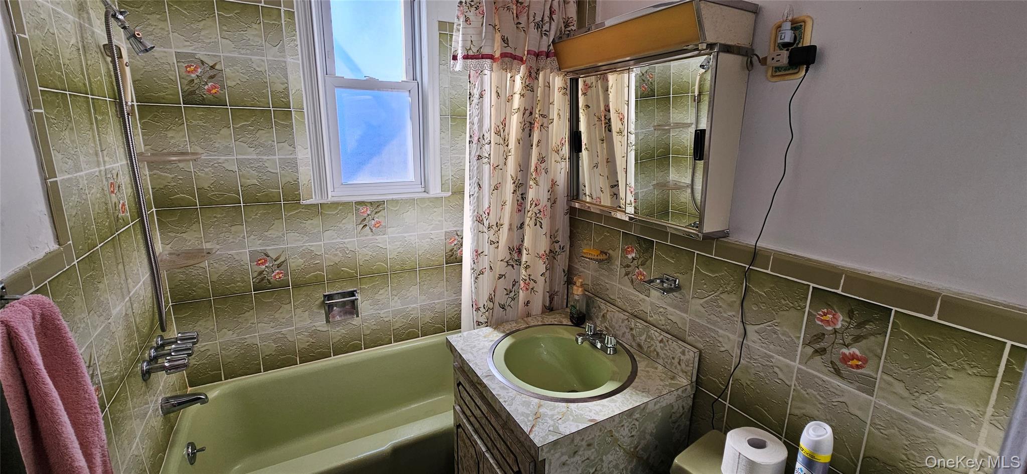 78-54 75th Street Queens, NY 11385 - Photo 26 of 31 Bathroom with vanity, bathtub / shower combination, and decorative backsplash