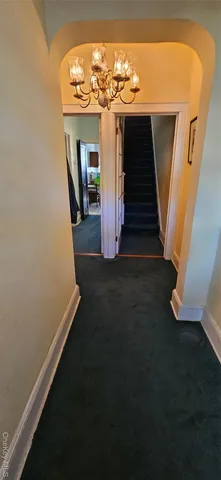 a view of a house with a yard and potted plants