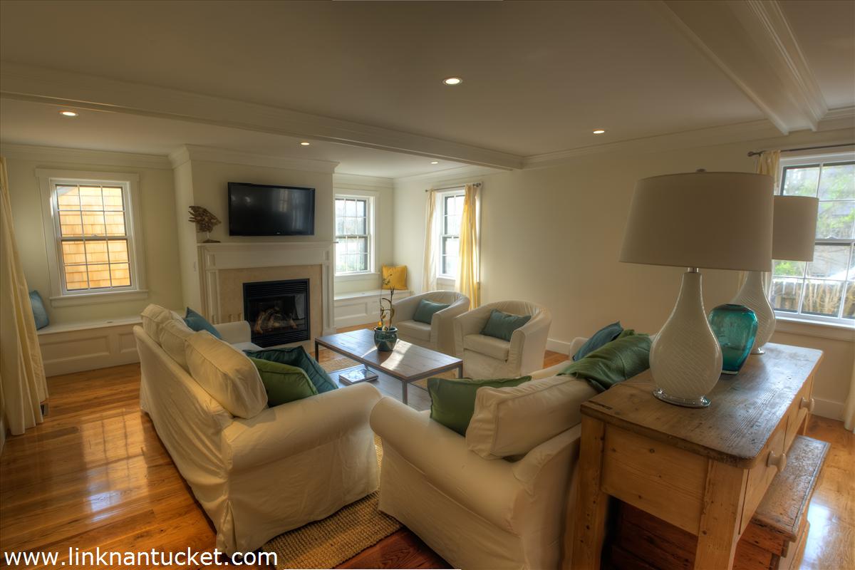4 Beaver Street Nantucket, MA 02554 - Photo 13 of 19 a living room with furniture a fireplace and a flat screen tv