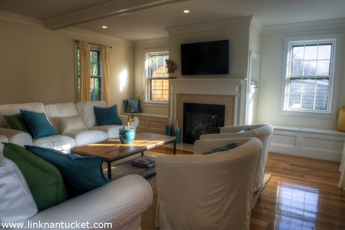 4 Beaver Street Nantucket, MA 02554 - Photo 14 of 19 a living room with furniture a flat screen tv and a fireplace