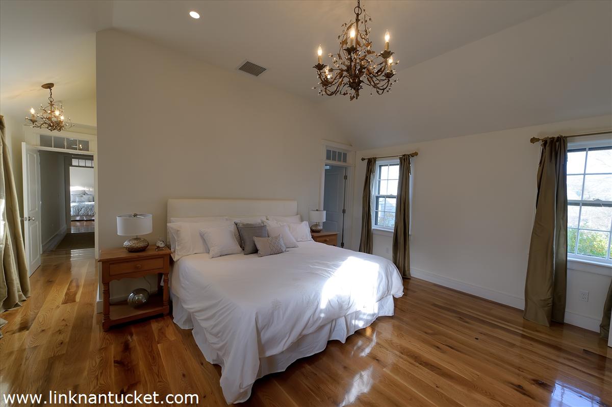 4 Beaver Street Nantucket, MA 02554 - Photo 15 of 19 a bedroom with a bed and wooden floor