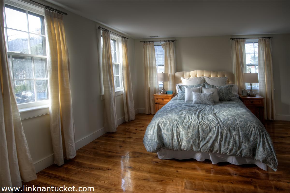 4 Beaver Street Nantucket, MA 02554 - Photo 17 of 19 a bedroom with a bed and glass door