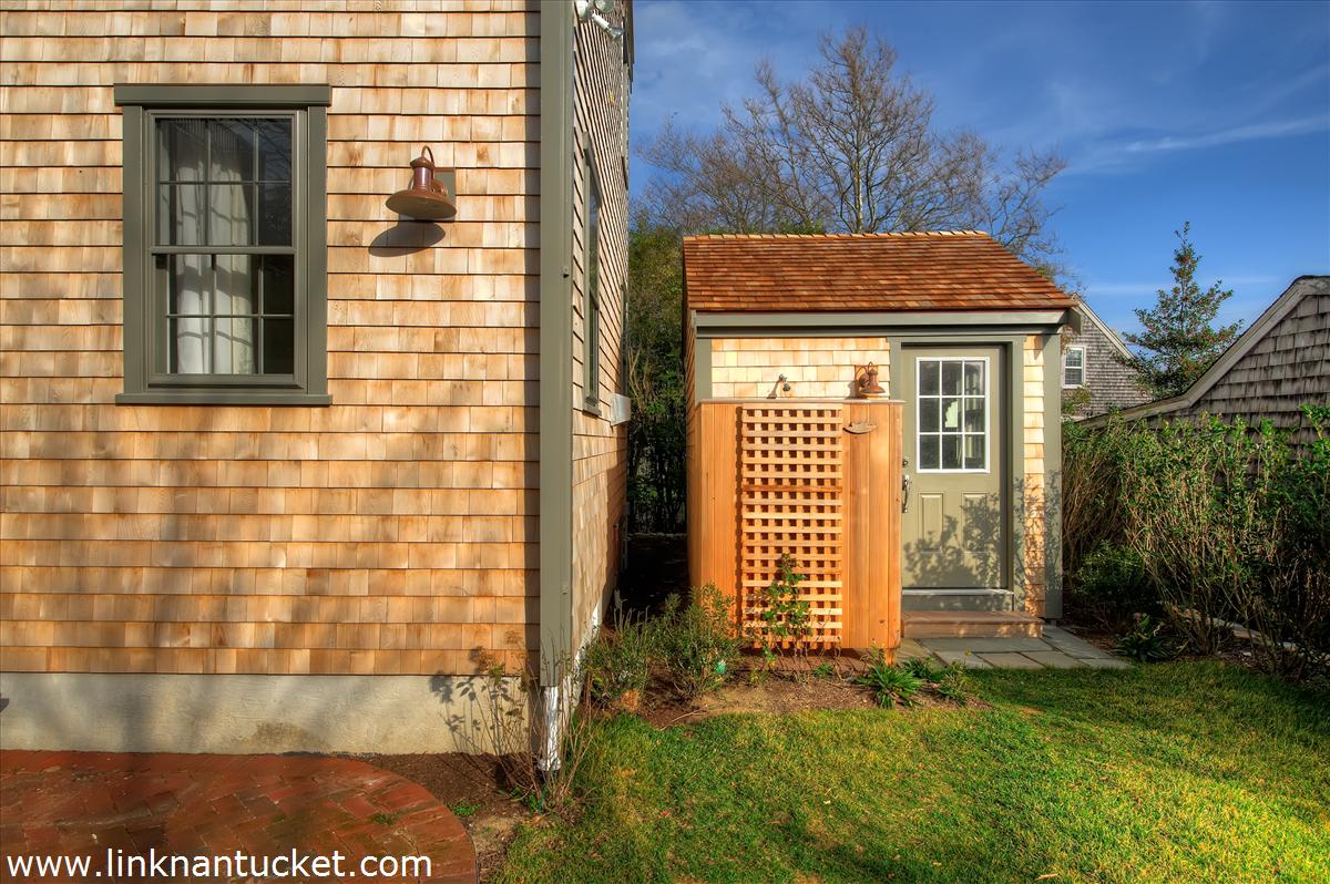 4 Beaver Street Nantucket, MA 02554 - Photo 4 of 19 a front view of a house with a yard