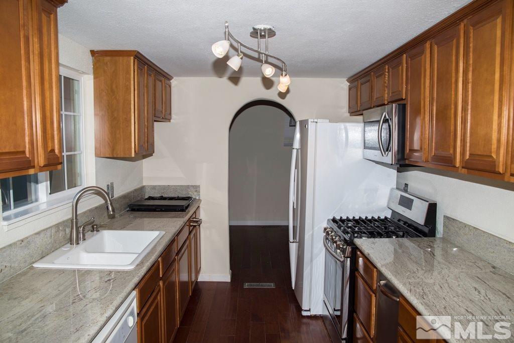 3735 Christopher Circle Reno, NV 89503 - Photo 2 of 19 a kitchen with stainless steel appliances granite countertop a sink a stove and refrigerator