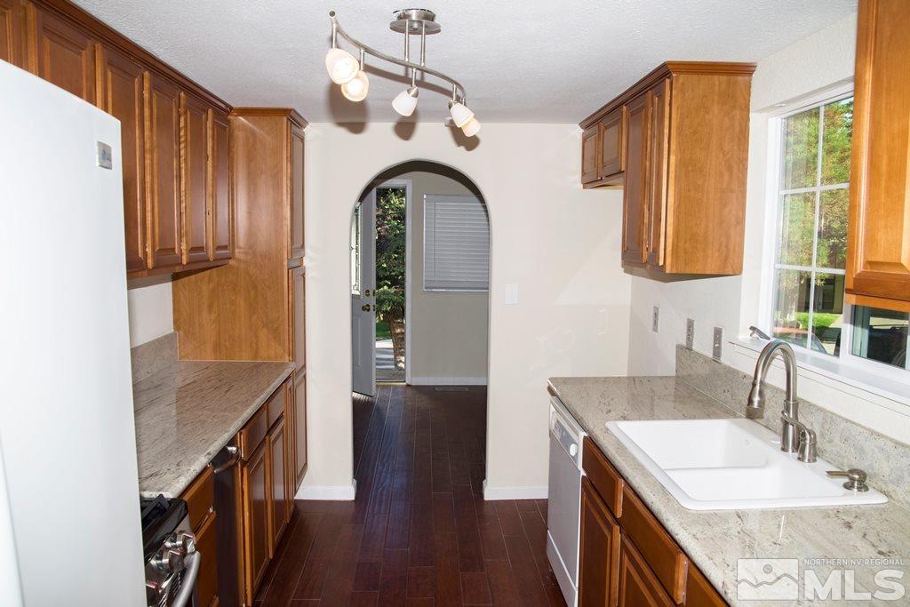 3735 Christopher Circle Reno, NV 89503 - Photo 3 of 19 a bathroom with a granite countertop sink a mirror and shower