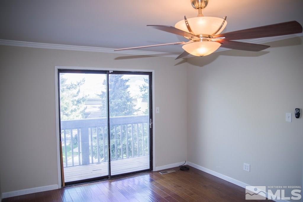 3735 Christopher Circle Reno, NV 89503 - Photo 10 of 19 a view of an empty room with wooden floor and a window