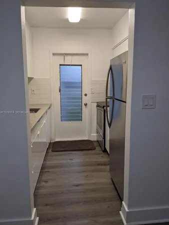a view of hallway with stairs and wooden floor