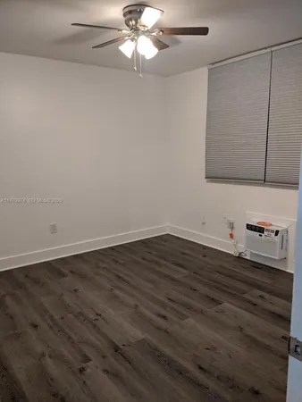 a view of a room with wooden floor and cabinet