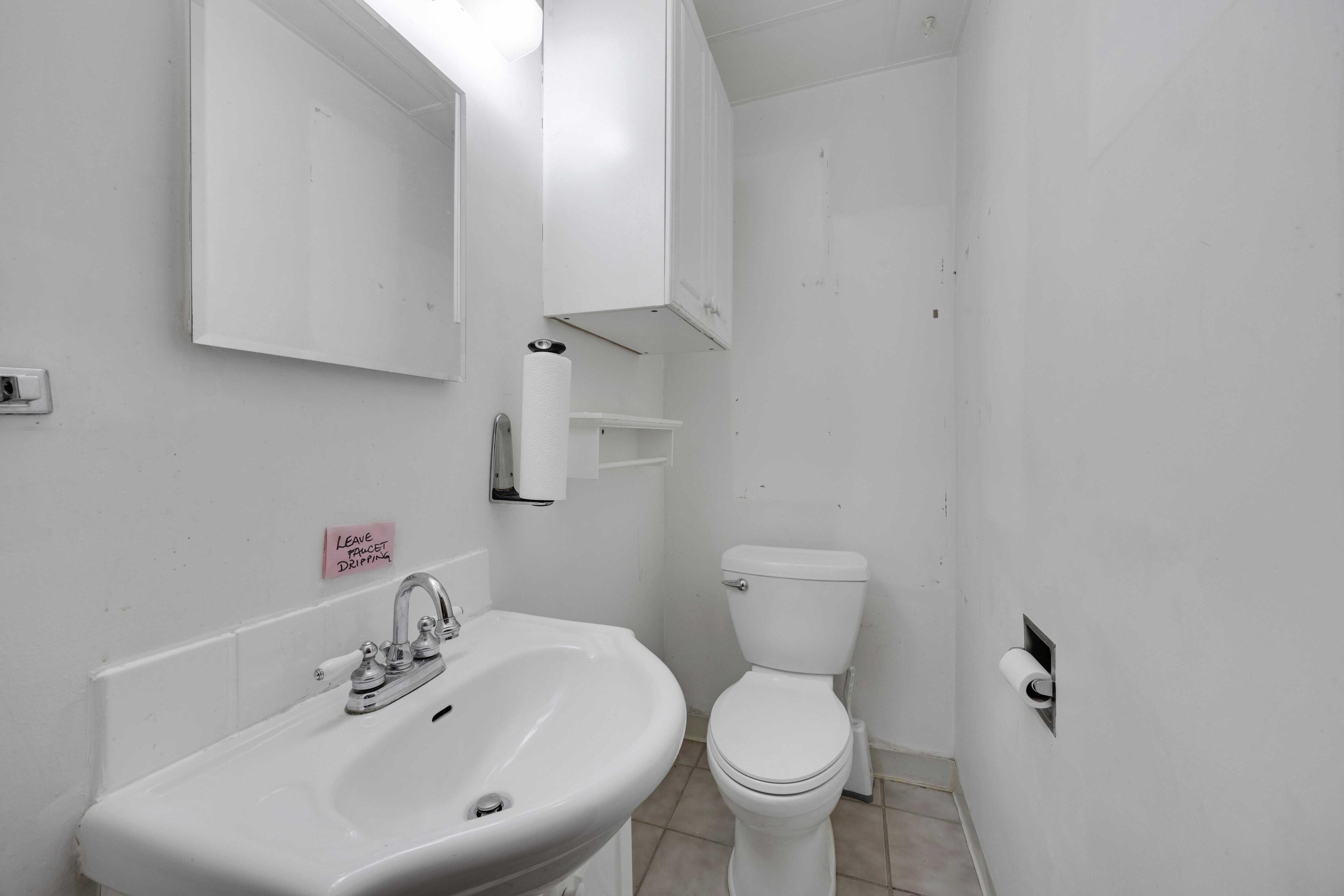 643 McKinley Street Gary, IN 46404 - Photo 11 of 22 a bathroom with a sink toilet and a mirror