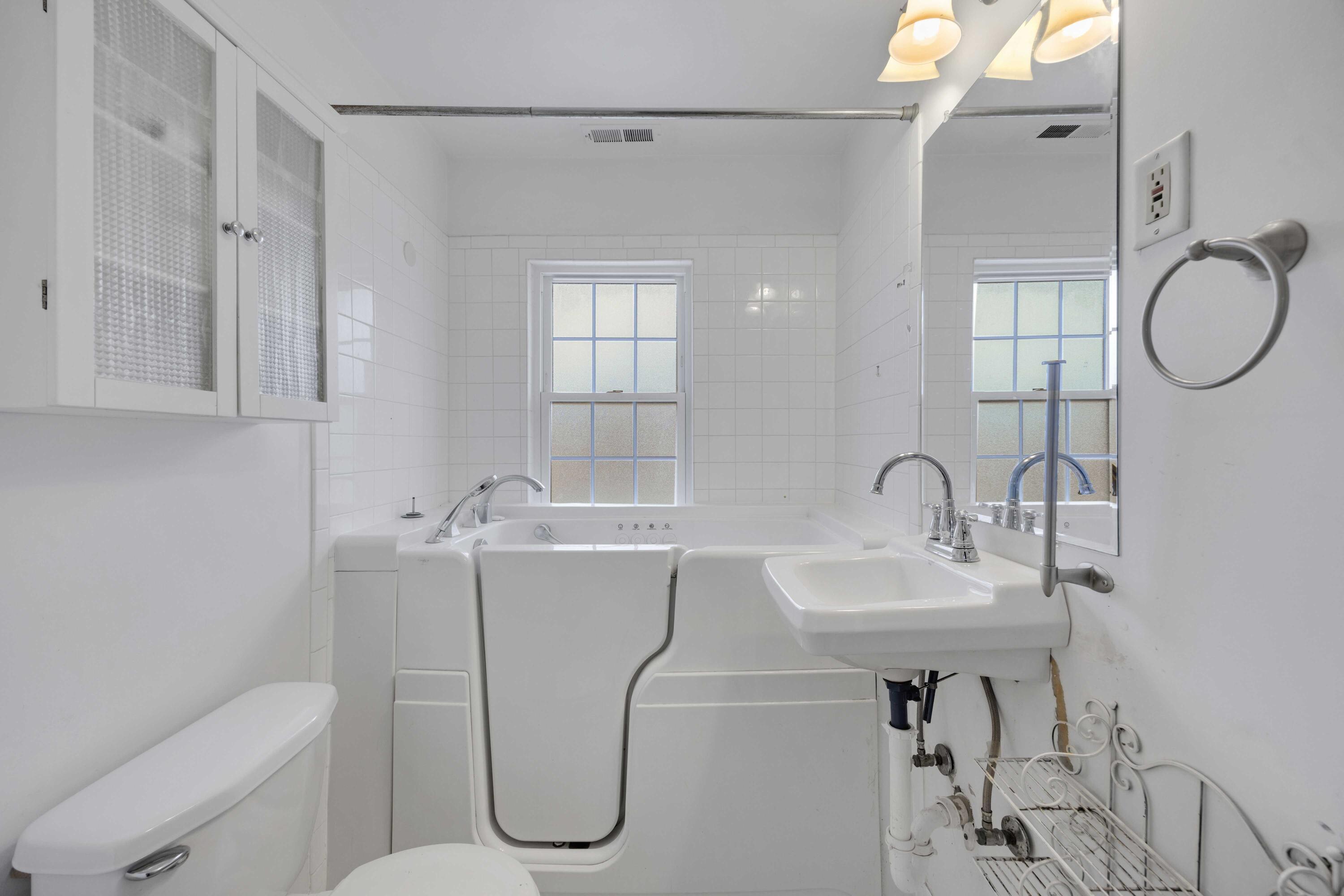 643 McKinley Street Gary, IN 46404 - Photo 16 of 22 a bathroom with a sink vanity toilet and shower