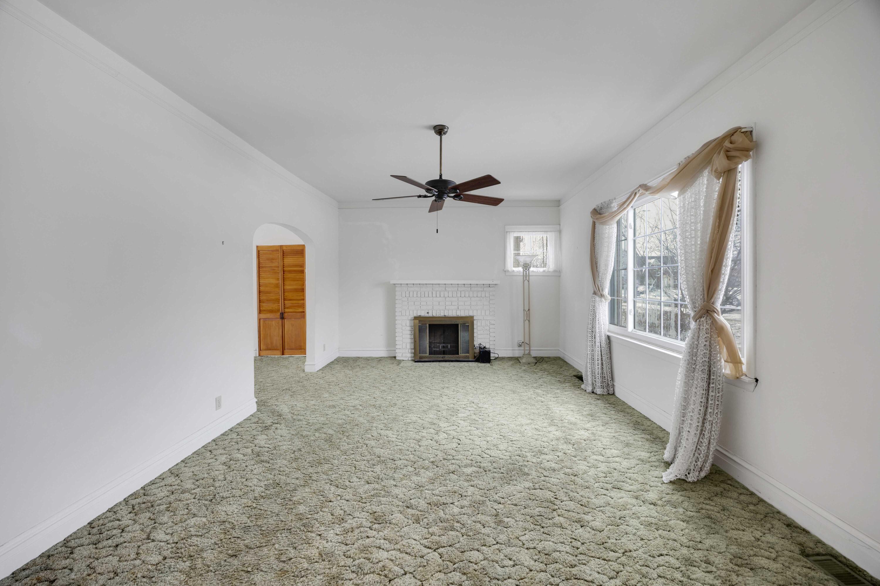 643 McKinley Street Gary, IN 46404 - Photo 2 of 22 an empty room with windows and fireplace