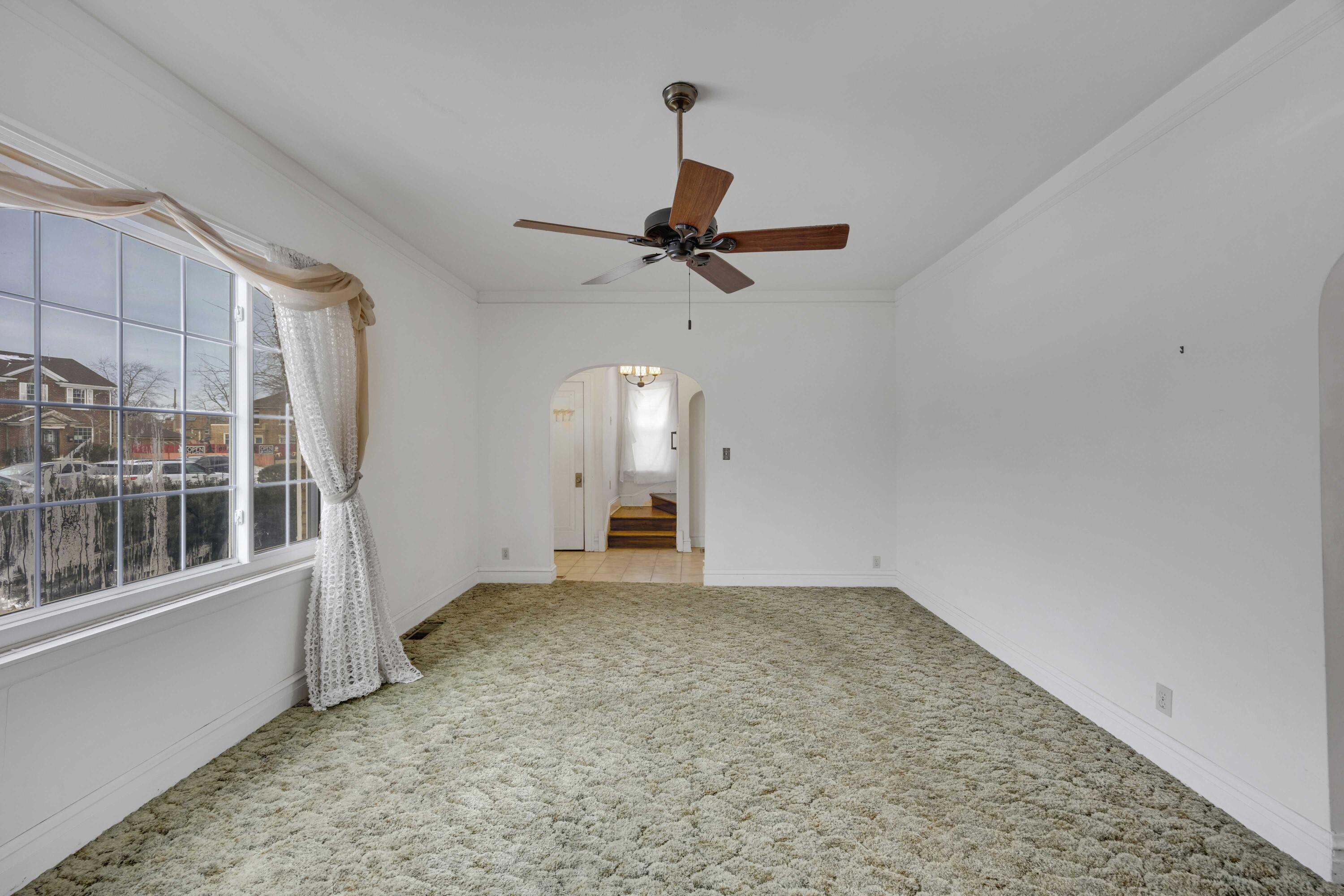 643 McKinley Street Gary, IN 46404 - Photo 4 of 22 an empty room with windows and fan