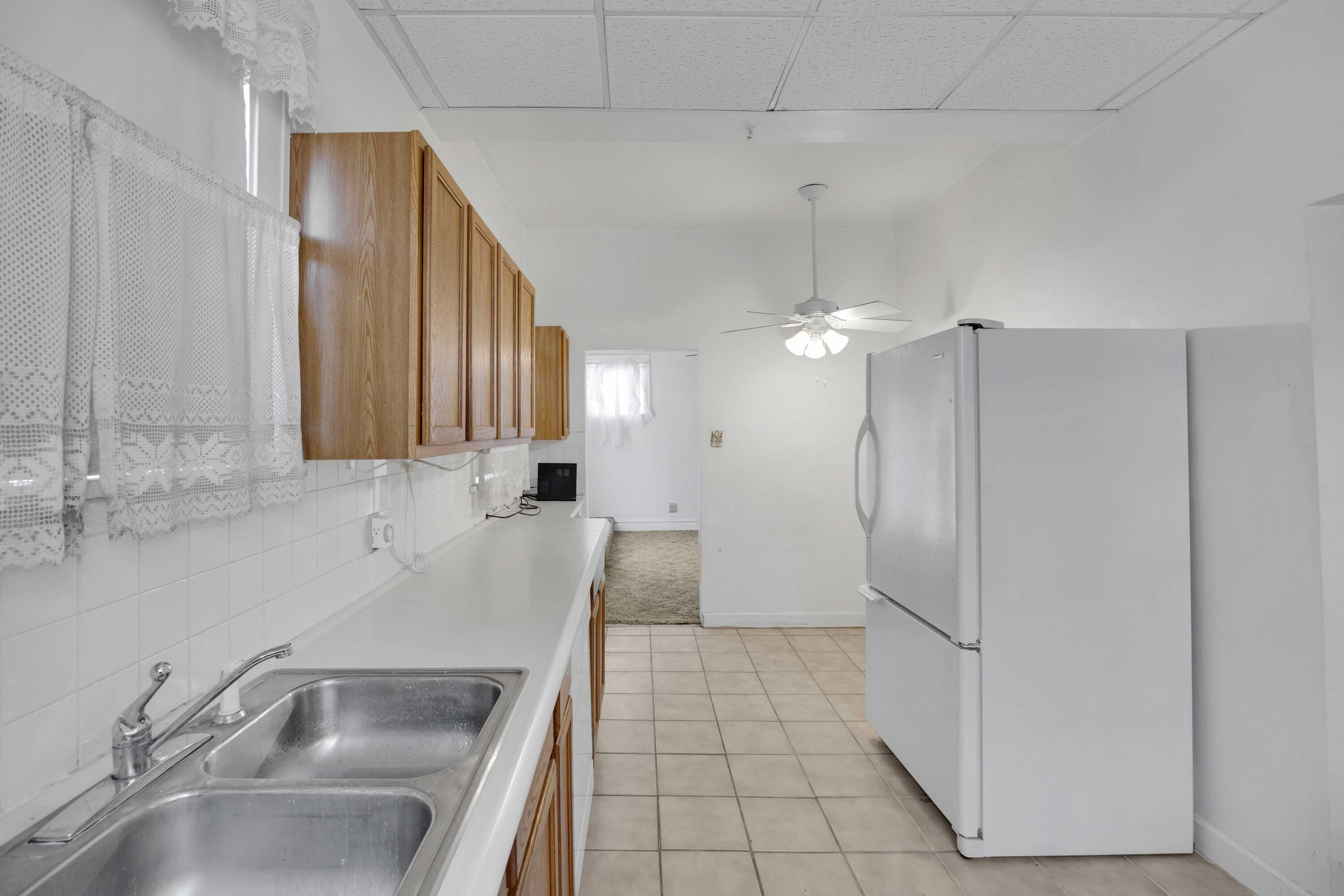 643 McKinley Street Gary, IN 46404 - Photo 8 of 22 a kitchen with stainless steel appliances granite countertop a sink and a refrigerator