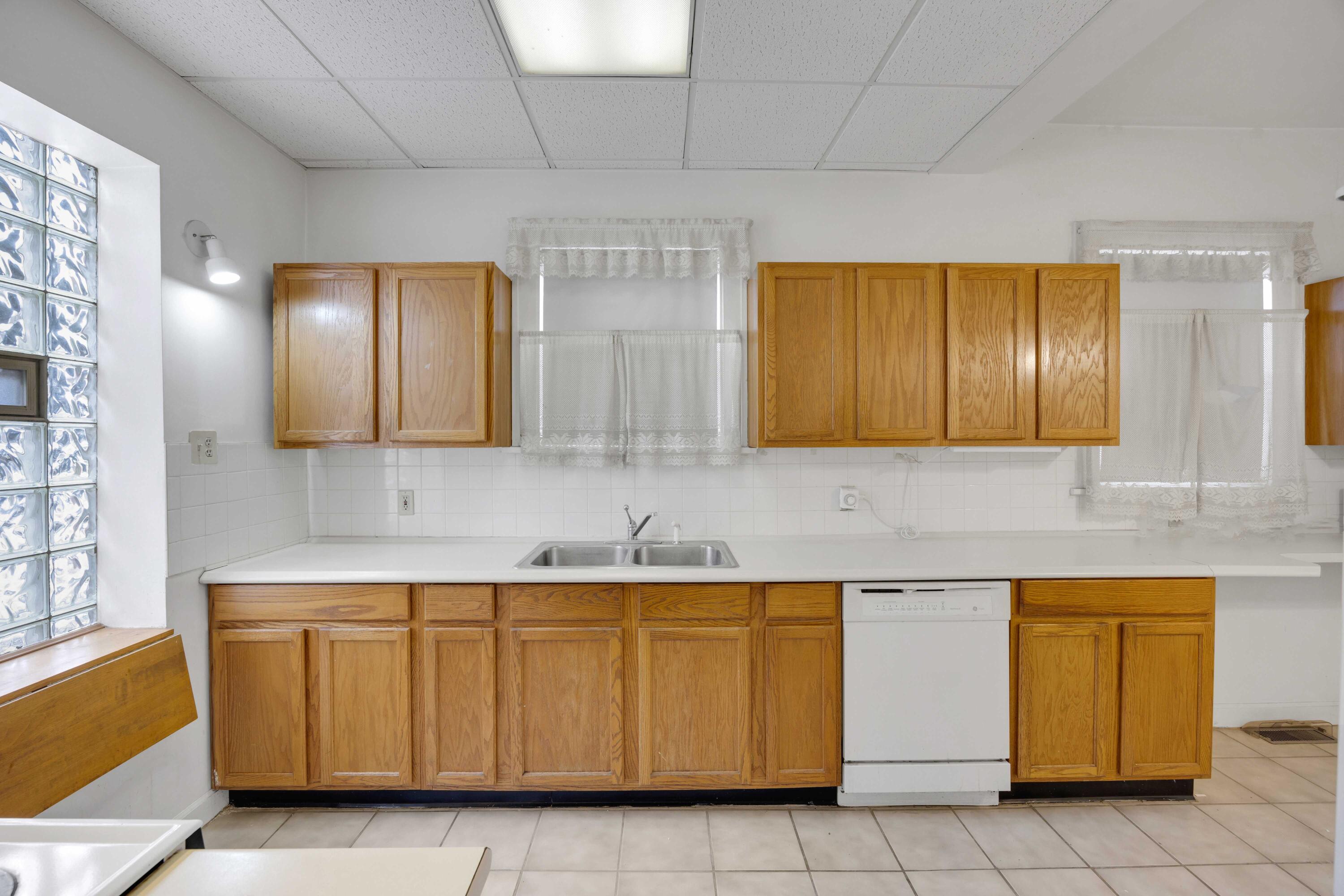 643 McKinley Street Gary, IN 46404 - Photo 9 of 22 a utility room with cabinets washer and dryer