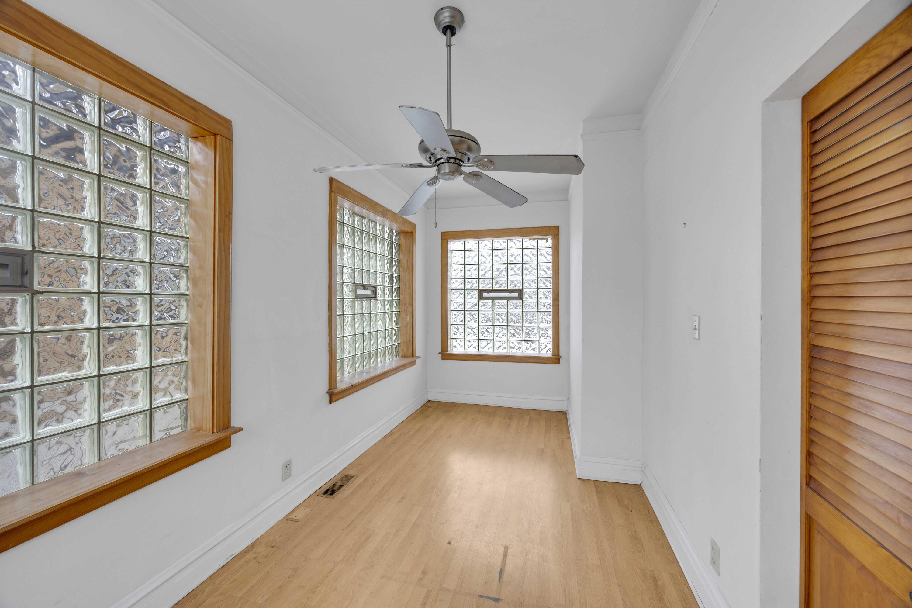 643 McKinley Street Gary, IN 46404 - Photo 10 of 22 a view of an empty room with a window and wooden floor