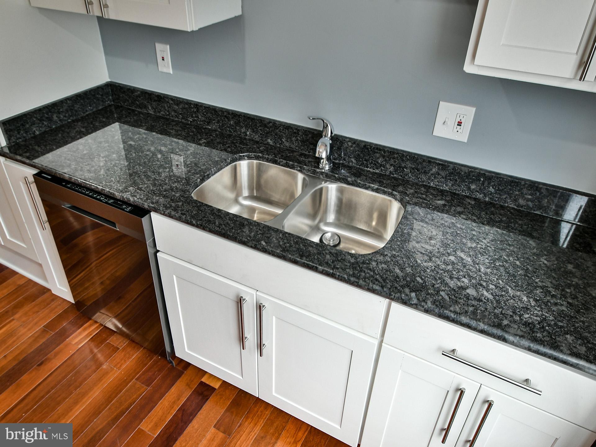 3511 Castle Way, Unit 312 Silver Spring, MD 20904 - Photo 11 of 34 a kitchen with granite countertop a sink and a stove