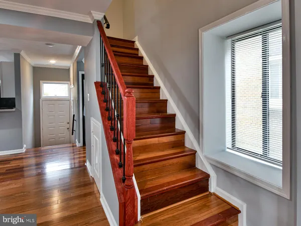 a view of entryway and hall with wooden floor