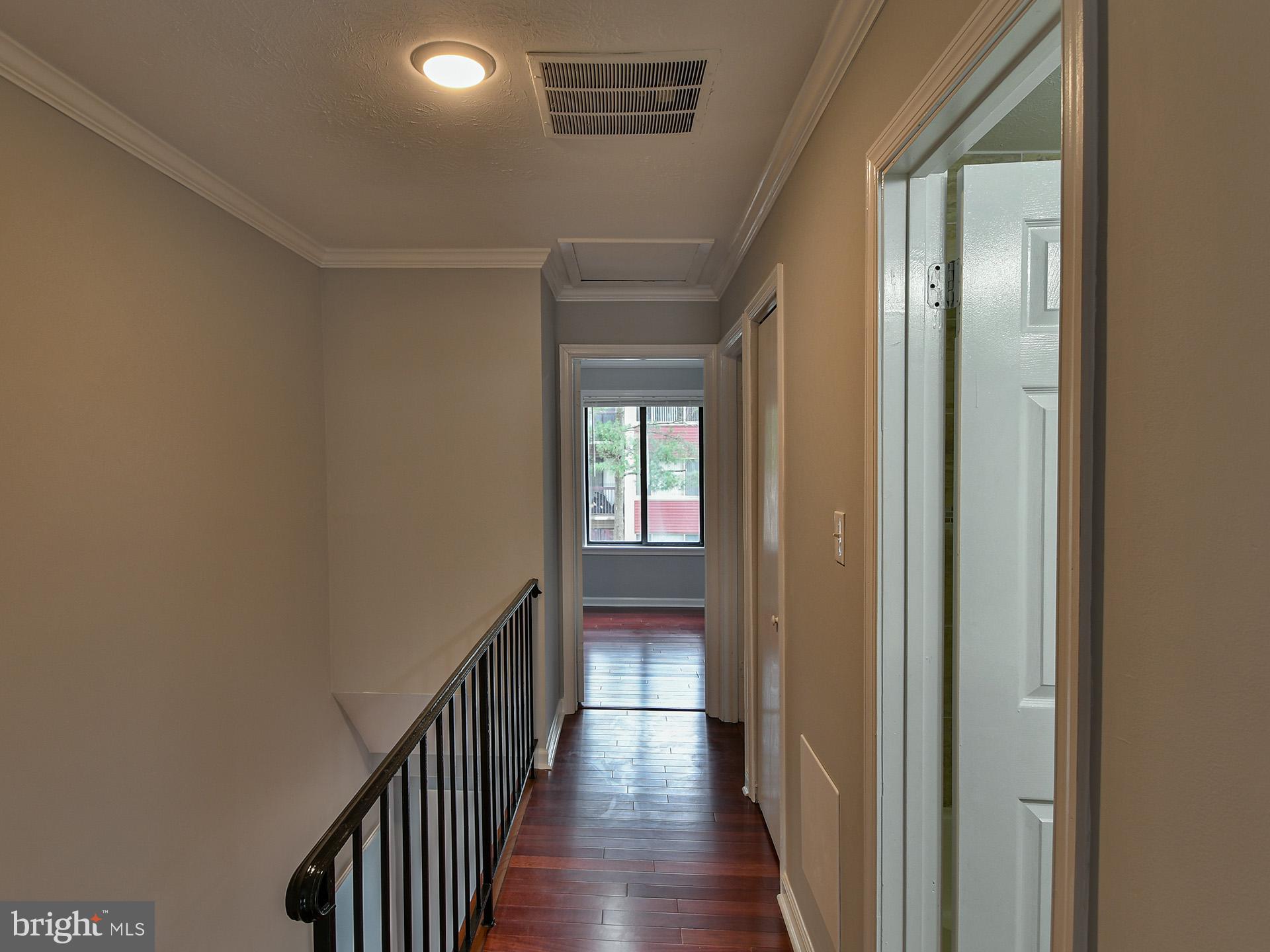 3511 Castle Way, Unit 312 Silver Spring, MD 20904 - Photo 19 of 34 a view of a hallway with wooden floor